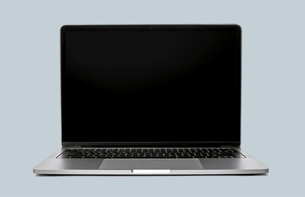 A MacBook laptop with a grey background. The computer is turned off or in sleep mode.