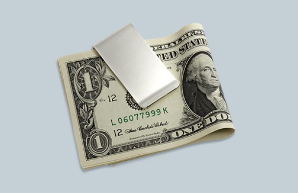 A money clip on display with a grey background.